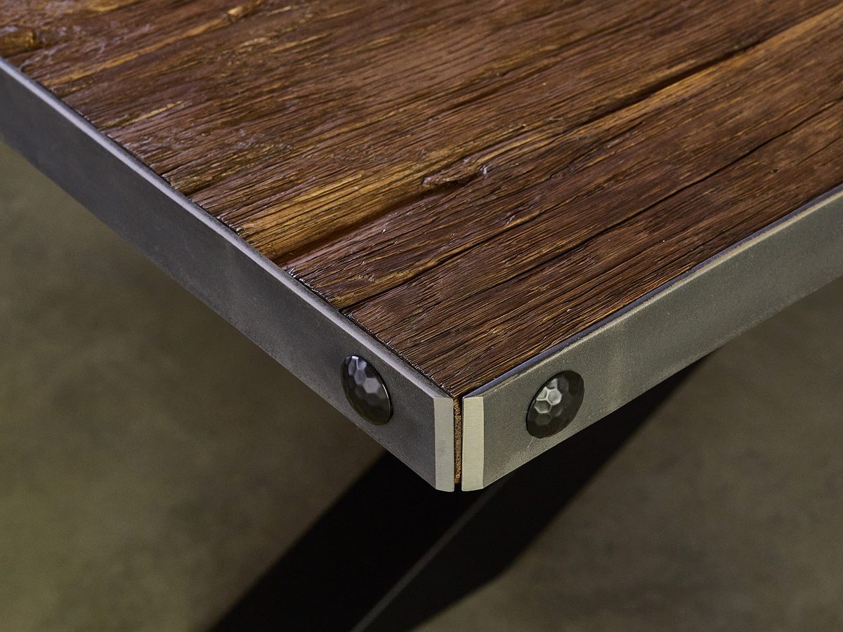BARSTONE reclaimed barn oak table corner with visible texture and metal edge detail